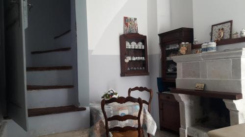a living room with a chair and a fireplace at Le dimore del Mercante in Luco neʼ Marsi