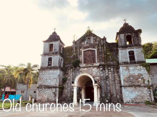 an old church with a cross on top of it at Squareville Subdivision in San Fernando