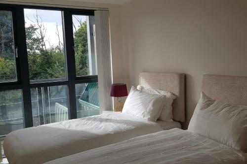 a bedroom with a white bed and a window at Garland Modern Apartment, Greenhithe 1 With Parking in Dartford