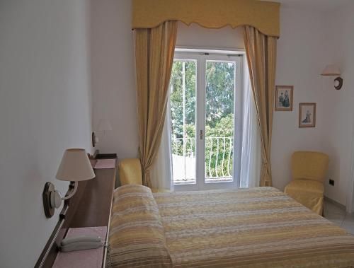 Postel nebo postele na pokoji v ubytování Hotel Biancamaria