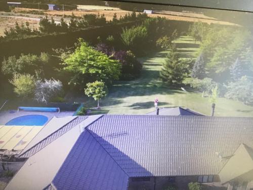 an overhead view of a house with a blue roof at Chester Oaks B&B in West Melton