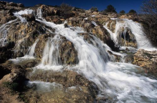 a waterfall on the side of a mountain at Doña Ruidera in Ruidera