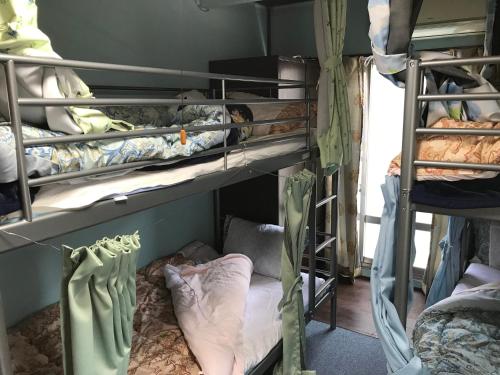a group of bunk beds in a room at Miyuki House Hostel 1 in Kashiwa