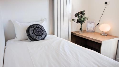 a bedroom with a bed with a pillow and a table at Kabuki Mt Buller in Mount Buller