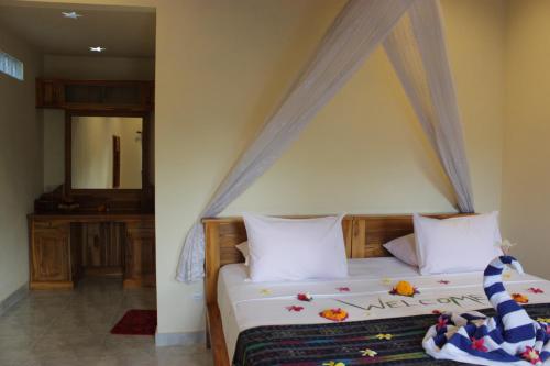 a bedroom with a bed with a canopy at Kubu Padi Wooden House in Pemuteran