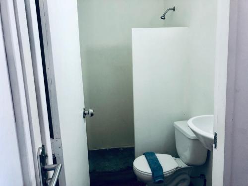 a bathroom with a toilet and a sink at Sleep'n'Ride in El Yaque