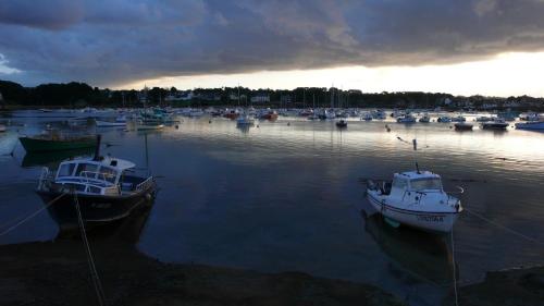 two boats are docked in a harbor on the water at Hôtel des Rochers in Perros-Guirec