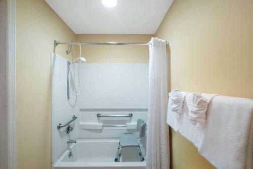 a bathroom with a shower with a shower curtain at Baymont by Wyndham Knoxville/Cedar Bluff in Knoxville