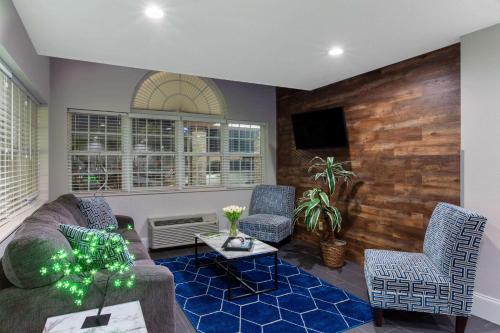 a living room with a couch and two chairs at Microtel Inn & Suites by Wyndham Augusta/Riverwatch in Augusta