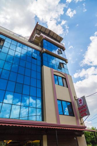 a building with blue glass windows on top of it at Ganapati Airport Hotel in Kathmandu