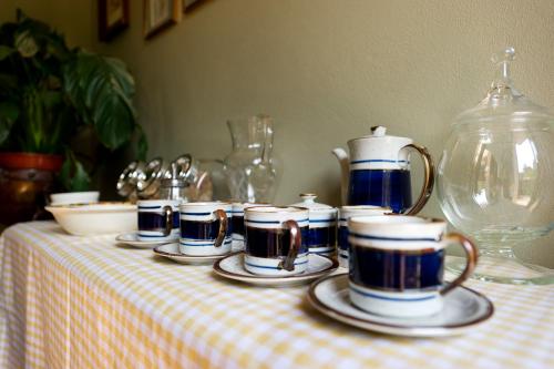 a group of cups and saucers on a table at B&B Torre Lara in Belgirate