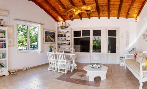 a living room with a couch and a table at Ostria in Agia Paraskevi