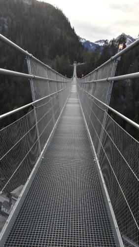 a bridge over a mountain with a long walkway at Haus Heiserer in Musau