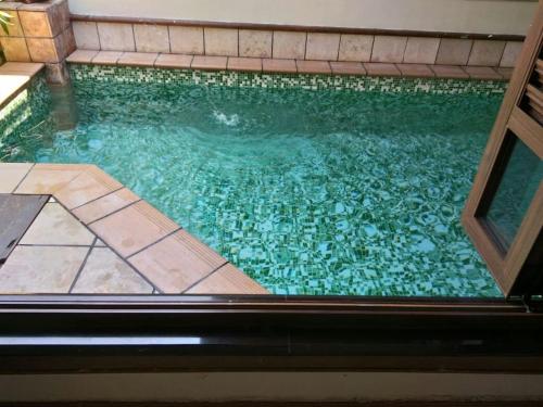 a large swimming pool with a tile floor at PORT DICKSON PRIVATE POOL VILLA WATER CHALET in Port Dickson