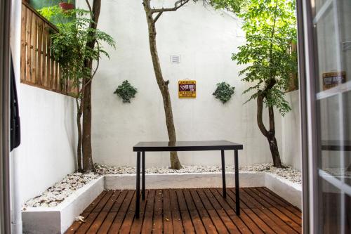 a black table sitting on a porch with trees at Vivenda Center Porto in Porto