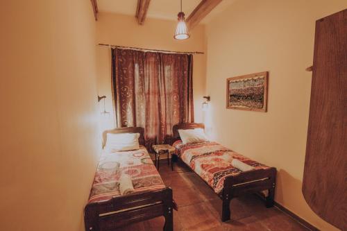 two beds in a small room with a window at Telavi Tel Aviv in Tʼelavi