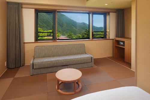 a living room with a couch and a table at Hakone Yutowa in Hakone