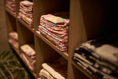 a book shelf filled with lots of folded clothes at Hakone Yutowa in Hakone
