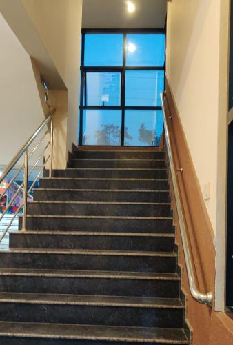 a staircase in a building with a window at Suvarna Suits in Mysore