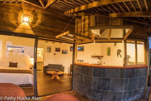 a large room with a bed and a room with a room at Kona Koa Lodge in Hanga Roa