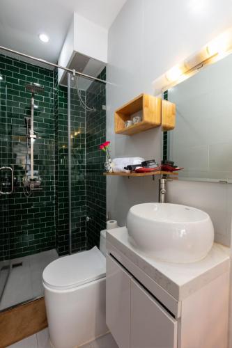 a bathroom with a sink and a toilet and a shower at Hanoi Center Silk Lullaby Hotel and Travel in Hanoi