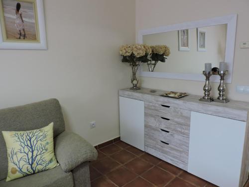 a living room with a dresser and a chair at Urbanización Manilva Beach 21 in Manilva