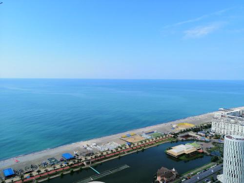 an aerial view of a beach and the ocean at ORBi CITY TOWERS in Batumi