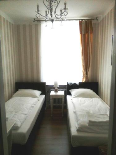 two beds in a room with a window at Liahof in Ullared