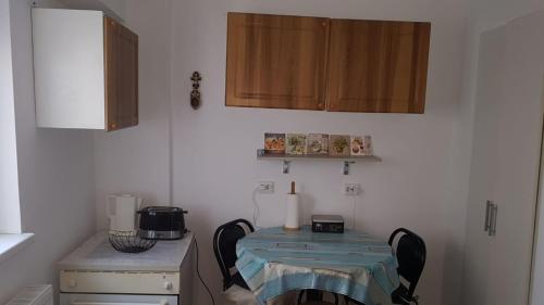 a small kitchen with a table with a candle on it at Faleza Nord Sea View Apartment in Constanţa