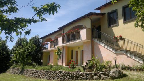 a building with flower boxes and balconies on it at Agriturismo Francadu in Santu Lussurgiu