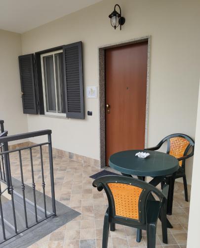 a patio with a table and chairs and a door at Caesar's B&B in Scafati