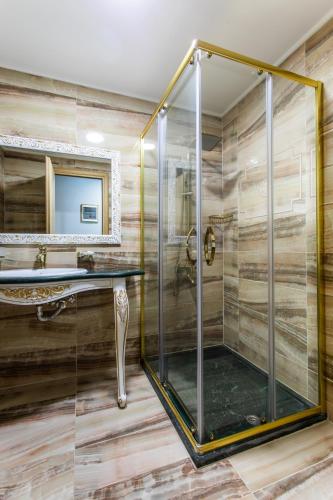 a bathroom with a shower with a glass shower stall at Wellness Santa Hotel - adults plus12 in Agia Triada