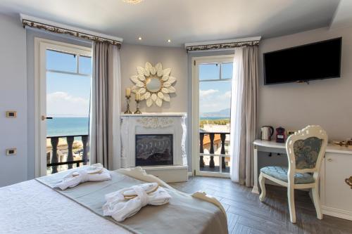a bedroom with a bed with a fireplace and a television at Wellness Santa Hotel - adults plus12 in Agia Triada