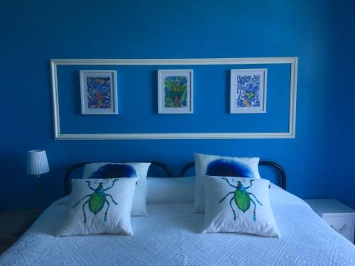 a blue bedroom with a bed with two pillows at Montanha, rio e mar... in Vila Nova de Cerveira
