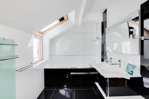 a white bathroom with a sink and a window at NOCNOC - Villa Paradis, piscine et rooftop au coeur de Nantes in Nantes