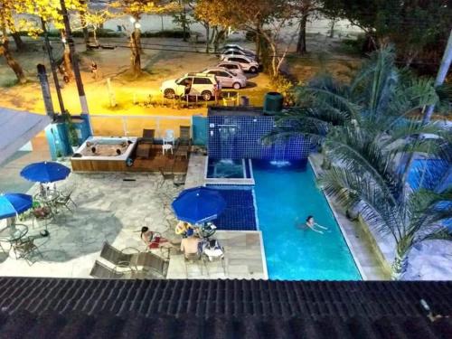 an overhead view of a swimming pool with umbrellas at Pousada Vistazul - Pé na Areia in Bertioga