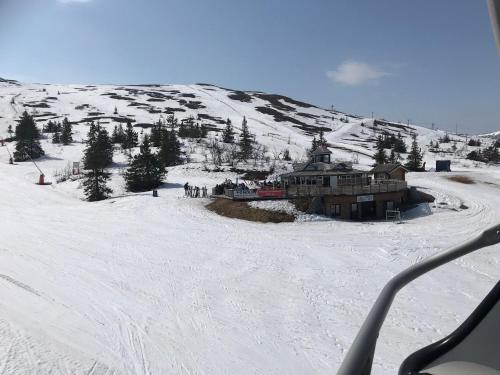 a ski lodge on a snow covered mountain with people at Lillebjørn in Trysil