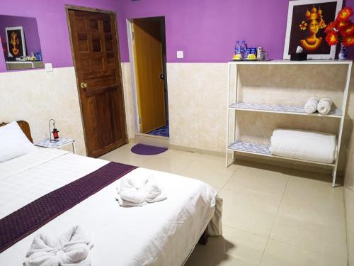 a bedroom with a bed with towels on it at Route 76 Guest House in Sen Monorom