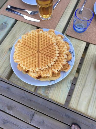 a stack of waffles on a plate on a table at Lillebjørn in Trysil