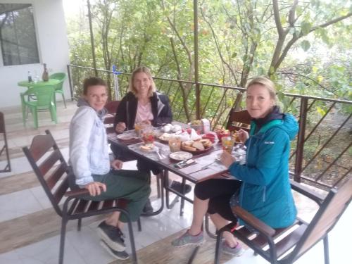 a group of three women sitting at a table at My home udabno in Udabno