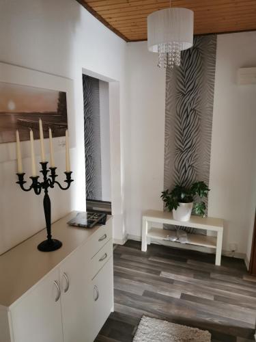 a living room with a chandelier and a table at Apartments Lindenstraße in Wilhelmshaven