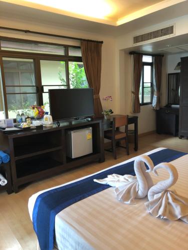 a hotel room with two swans on a bed at Samui Mermaid Beachfront in Bang Rak Beach