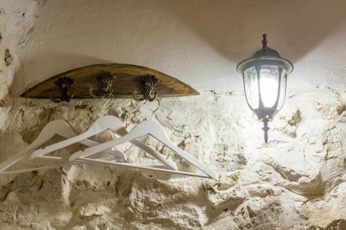 a street light next to a surfboard on a wall at Rijeka Crnojevića, Lidija Apartment in Rijeka Crnojevića