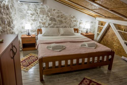 a bedroom with a bed with two towels on it at Rijeka Crnojevića, Lidija Apartment in Rijeka Crnojevića