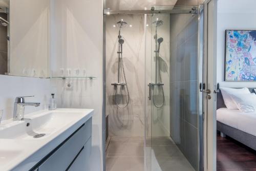 a bathroom with a shower and a sink at The Old Lady in Amsterdam