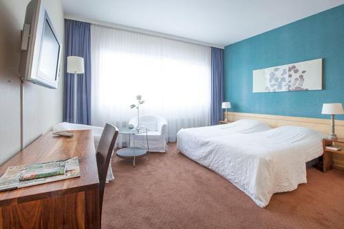 Postel nebo postele na pokoji v ubytování Hotel Gevers