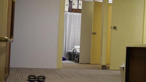 a hallway with two pairs of shoes in a room at Minshuku Chatamago in Nagasaki