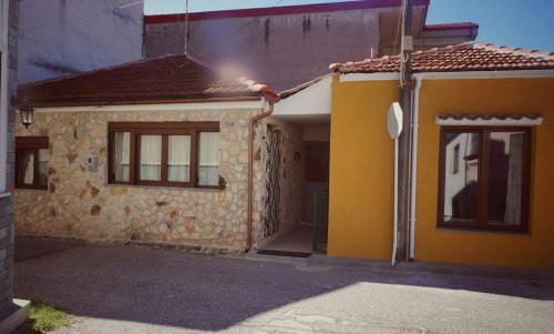 a yellow house with a door and a window at Village House Grevena in Grevena