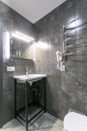 a bathroom with a sink and a shower at Motel Sun Lit in Ivano-Frankivsʼk