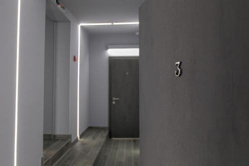 an empty hallway with a door with a light on it at Motel Sun Lit in Ivano-Frankivsʼk